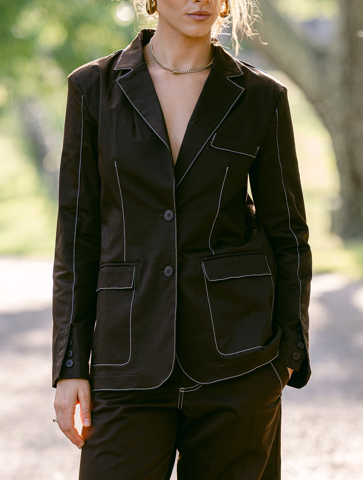 model wearing a brown stitching blazer