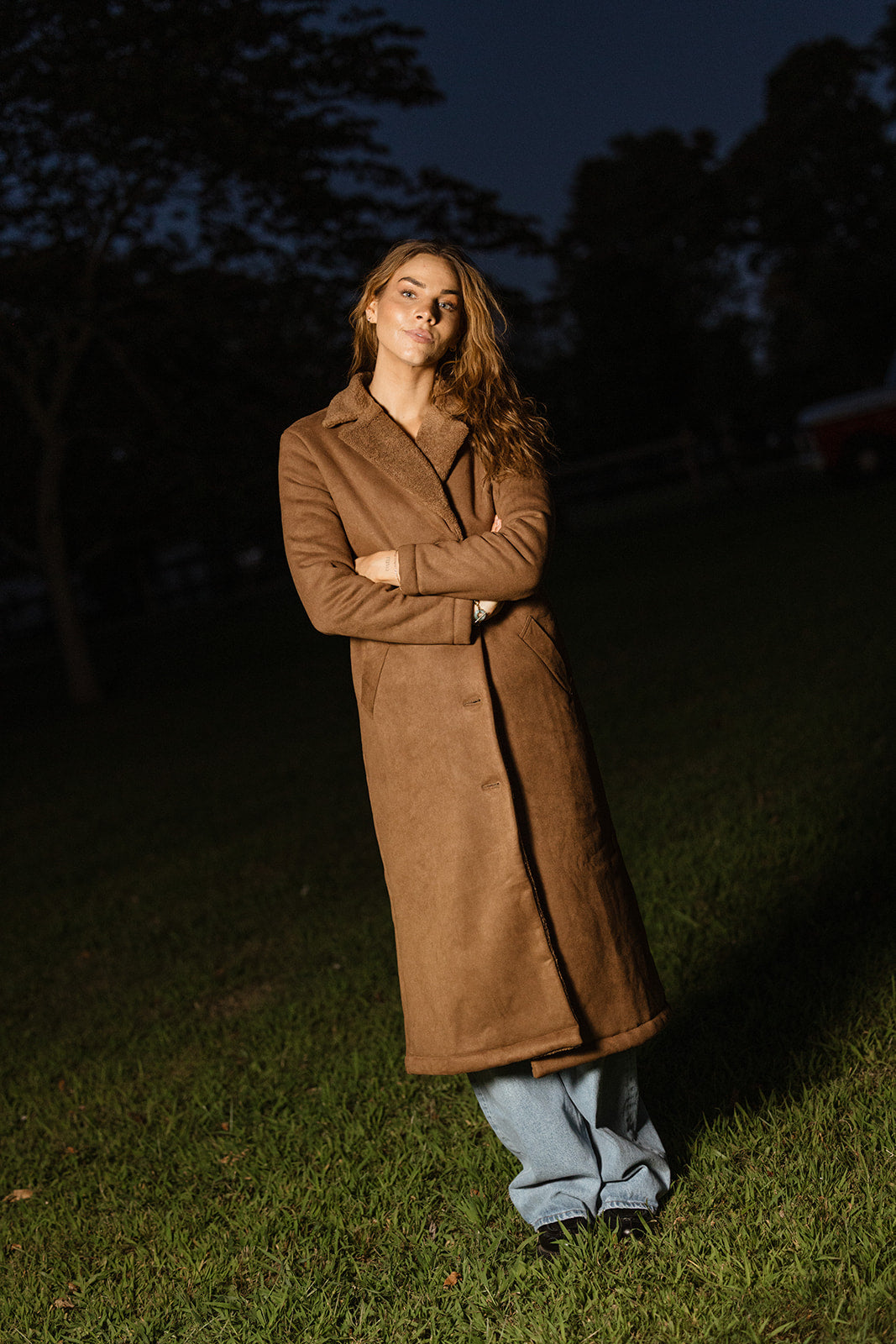 model wearing a brown suede shearling trench coat