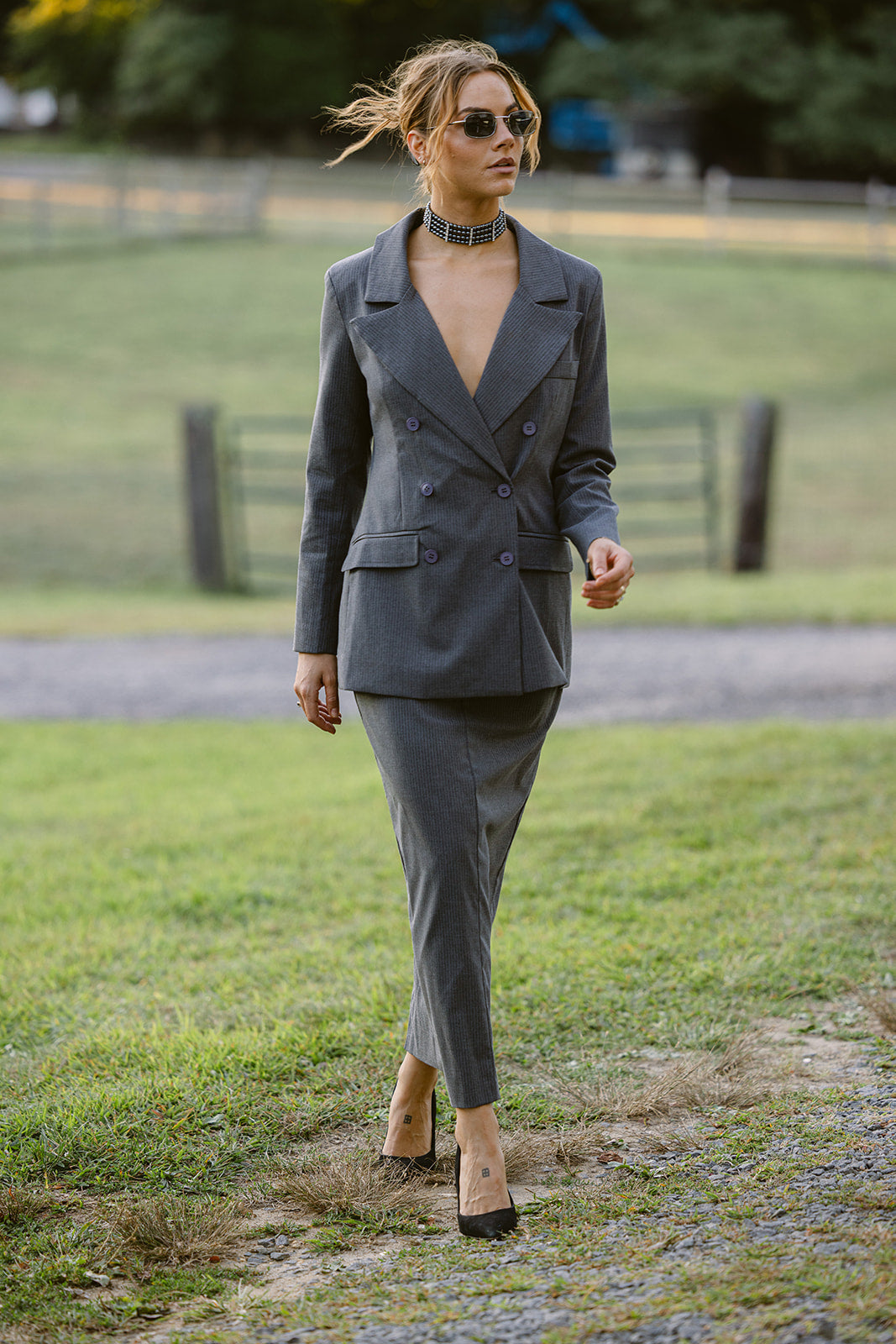 woman wearing a grey pinstripe double breasted blazer 