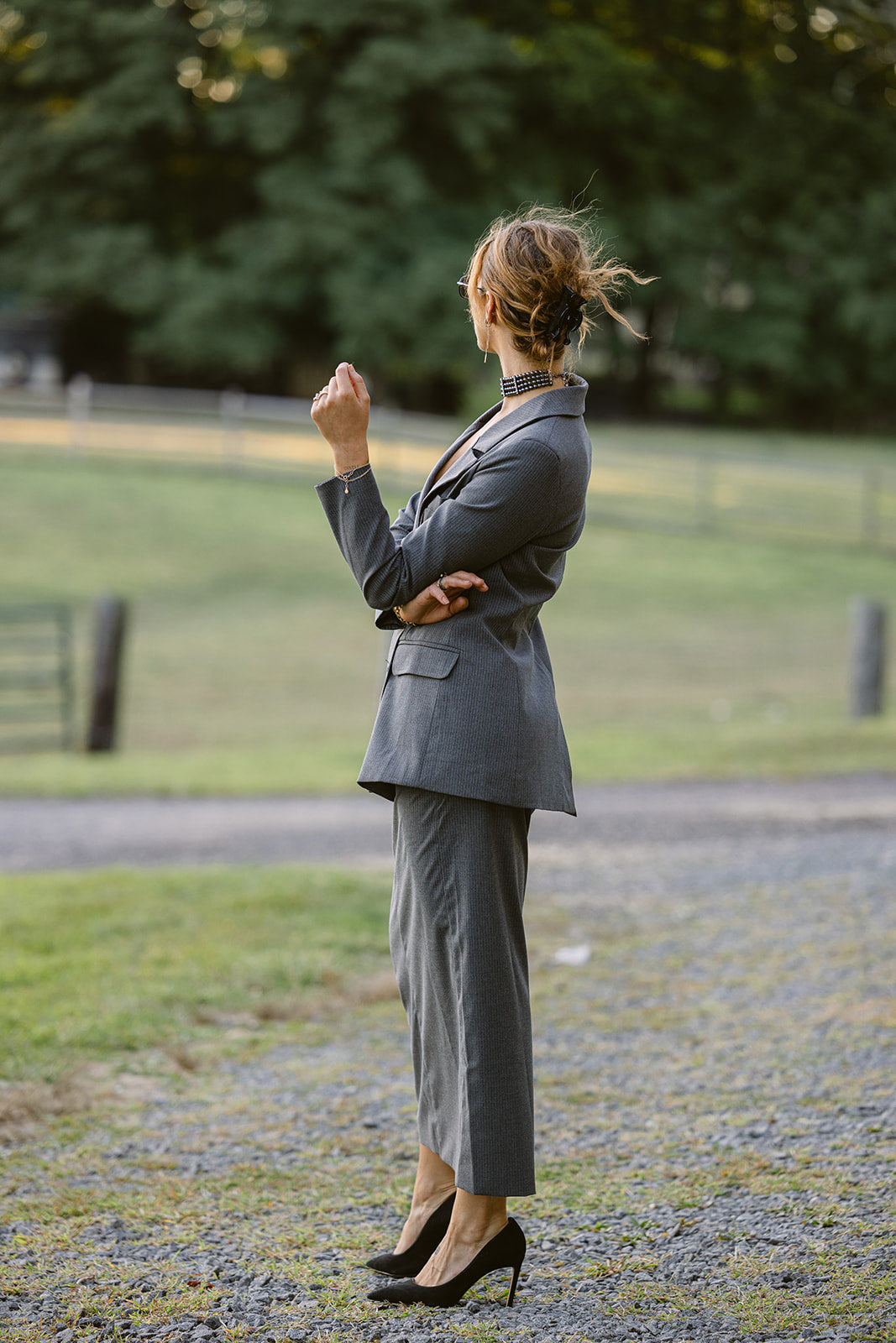women wearing a grey pinstripe double breasted blazer with a matching maxi skirt 