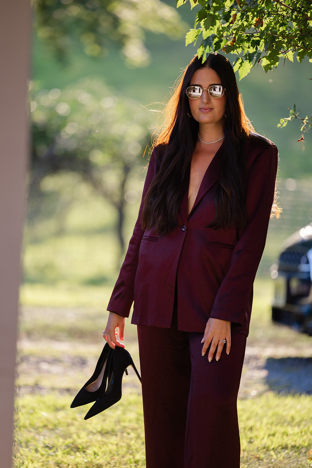 Model in cabernet satin pant suit