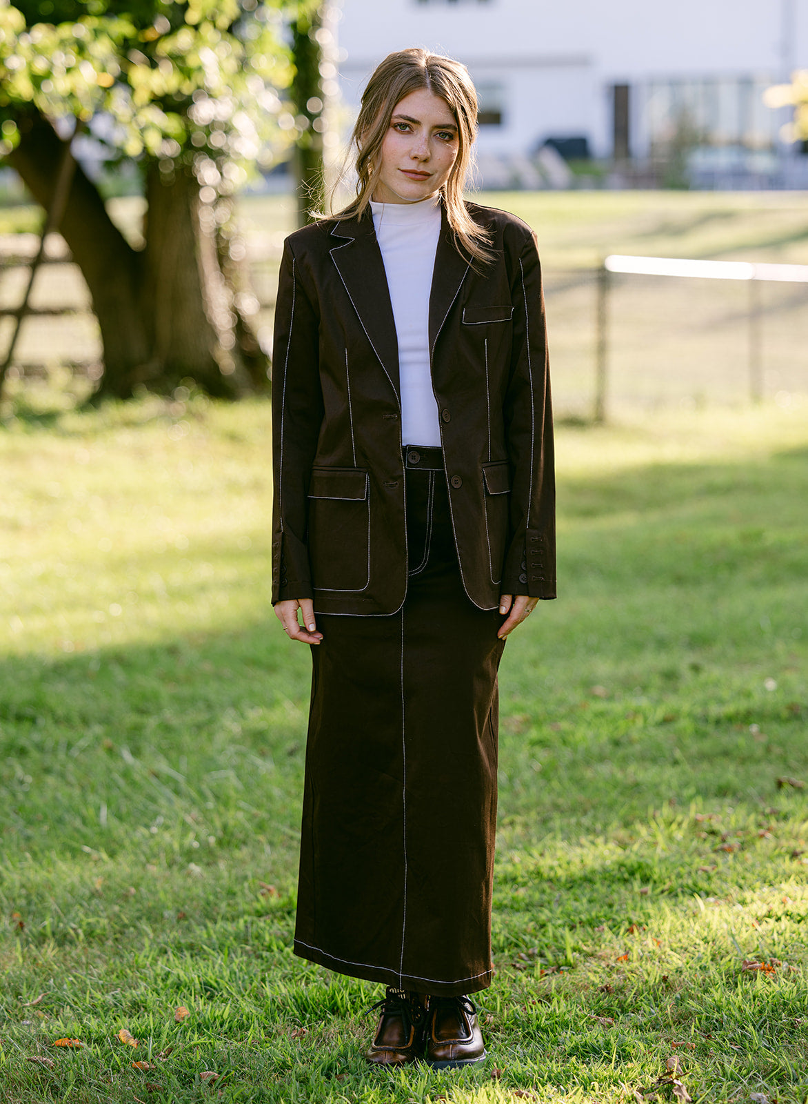 model wearing a brown stitching blazer and maxi skirt