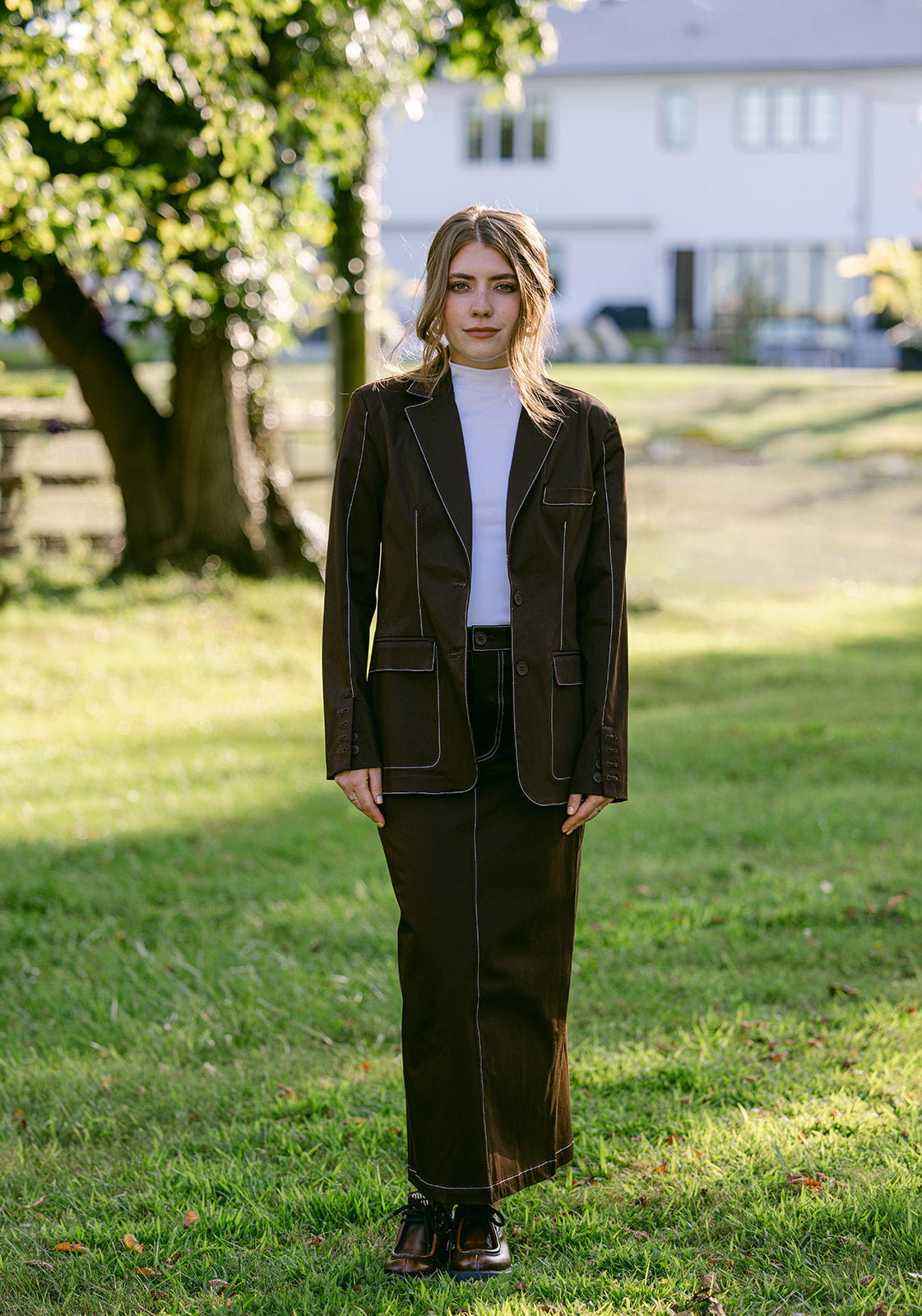 women wearing a brown stitching blazer and maxi skirt