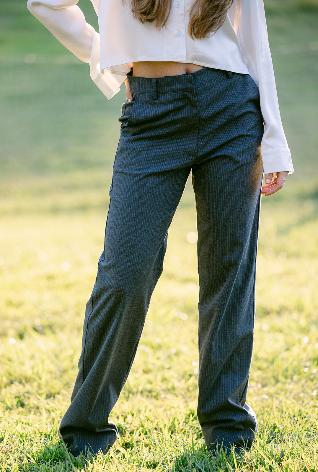 woman wearing a grey pinstripe trouser